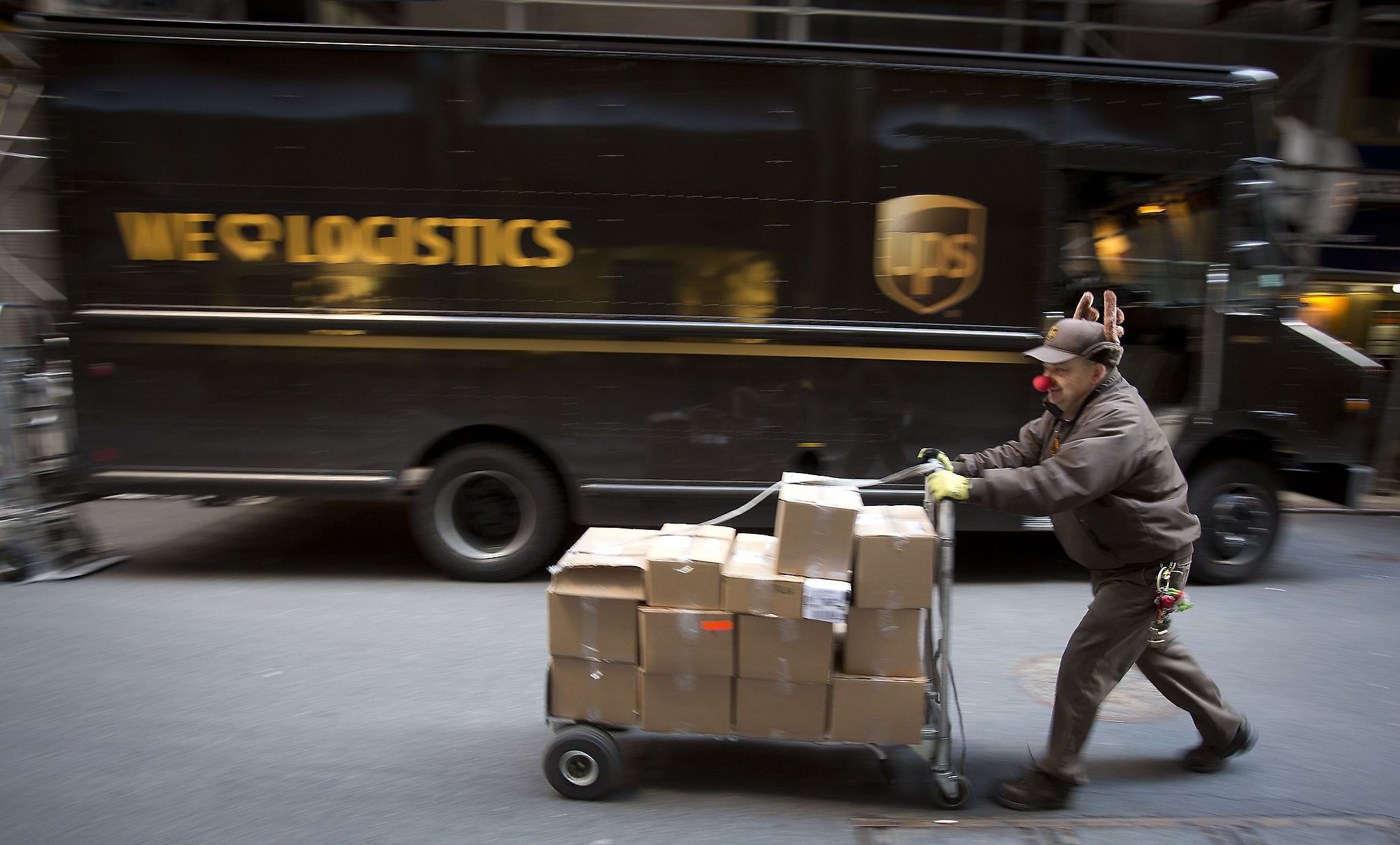 A UPS delivery man prepares to deliver packages on Christmas Eve in New York