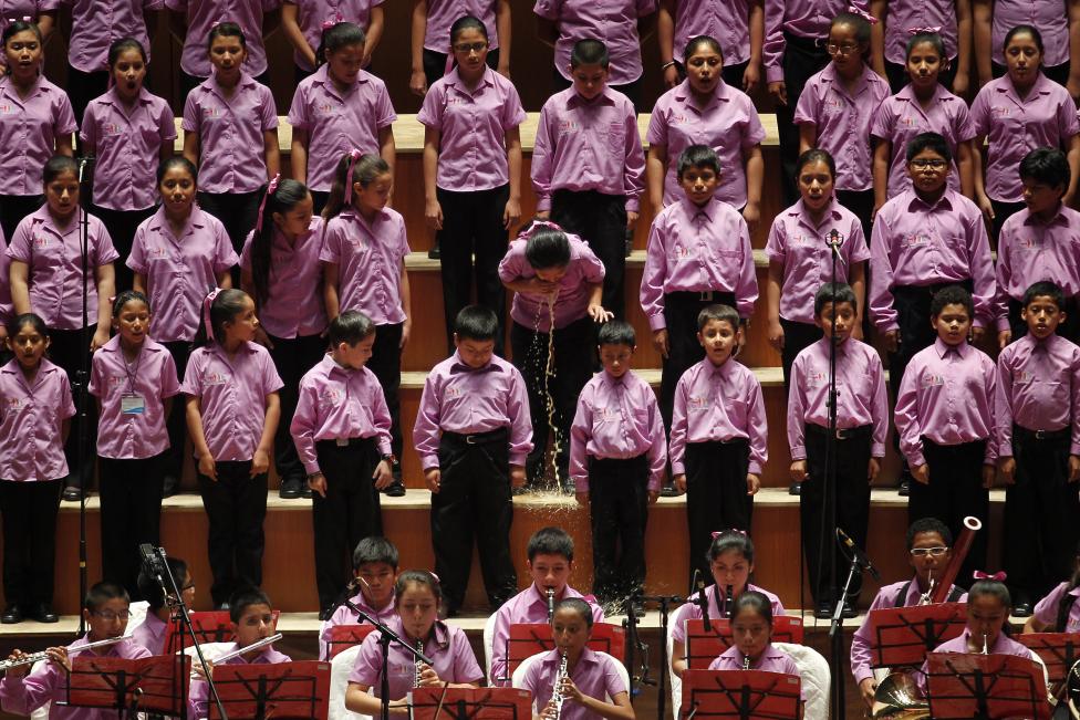 A young member of the choir of "Sinfonia por el Peru" vomits before performing with Peruvian tenor Juan Diego Florez at Lima's National Theatre