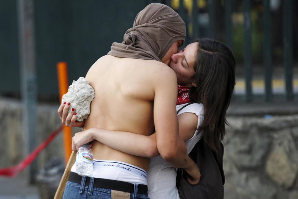 Anti-government protesters kiss during a protest in Caracas