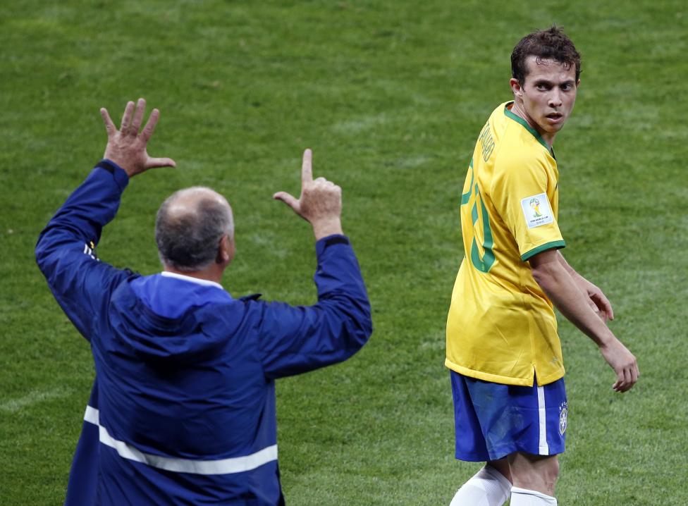 Brazil's coach Luiz Felipe Scolari gestures to Bernard during their 2014 World Cup semi-finals against Germany at the Mineirao stadium in Belo Horizonte